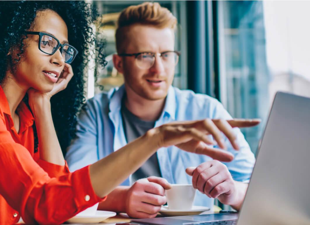 Two people talking about what's on their computer